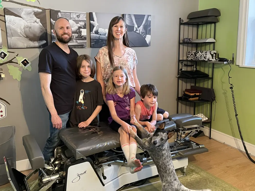 Dr. Emilie Perras and Martin Perras with children seated on treatment table